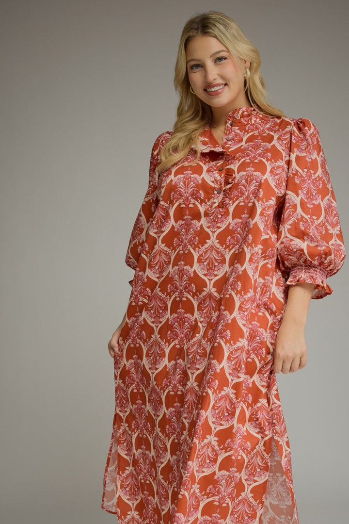 Nora Ruffle Midi Dress in red with white damask print, button-front, ruffle collar, and balloon sleeves with ruffled cuffs. Available in various sizes.