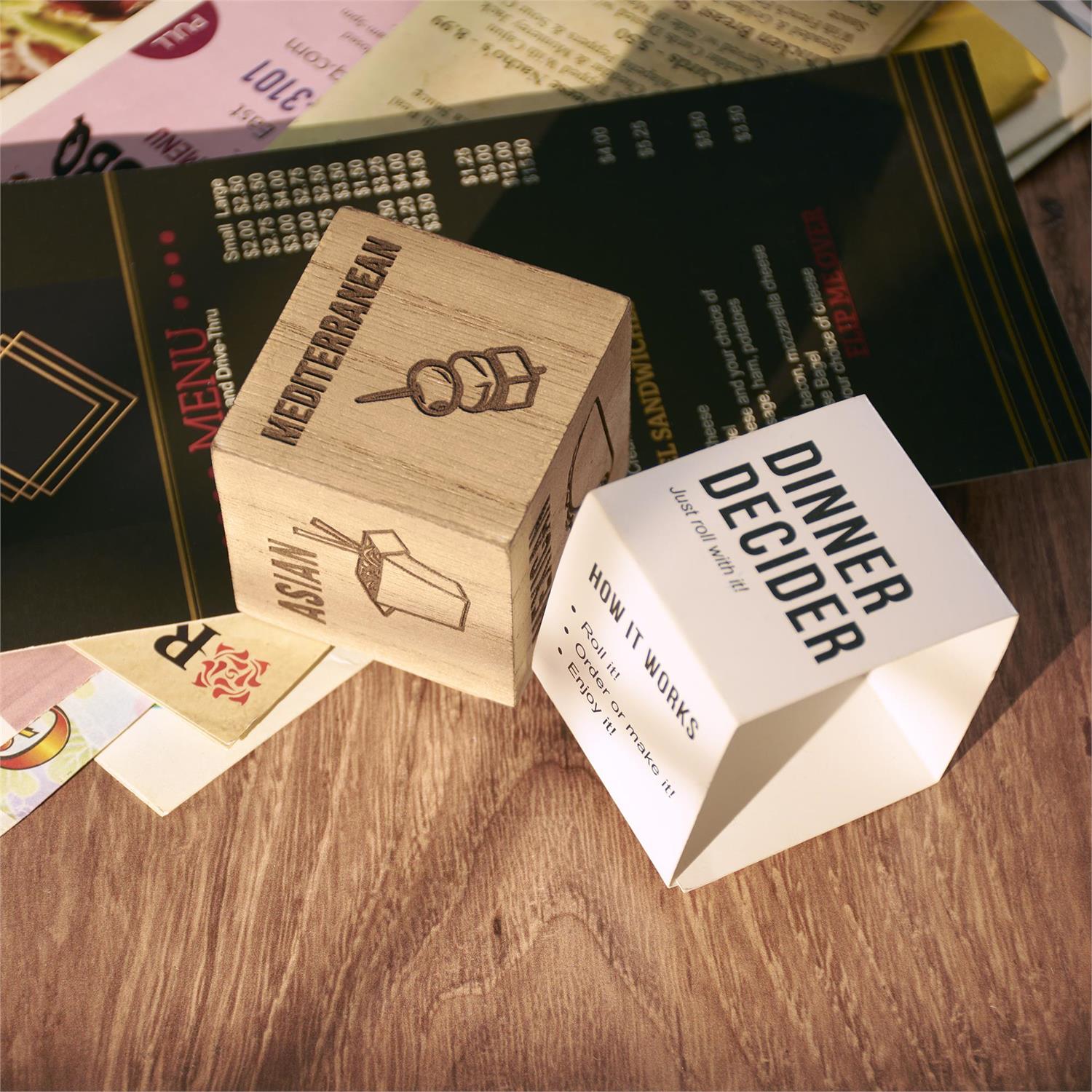 The "Dinner Decision Dice" is a white cube featuring options like "Pizza" and "BBQ" to simplify meal choices. Size: Standard dice dimensions.