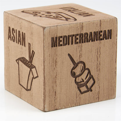 The Dinner Decision Dice is a wooden cube with food icons: Asian (noodle box), Mediterranean (kebab skewer), and Italian (pizza slice) to inspire meal choices. Size: Standard cube dimensions.