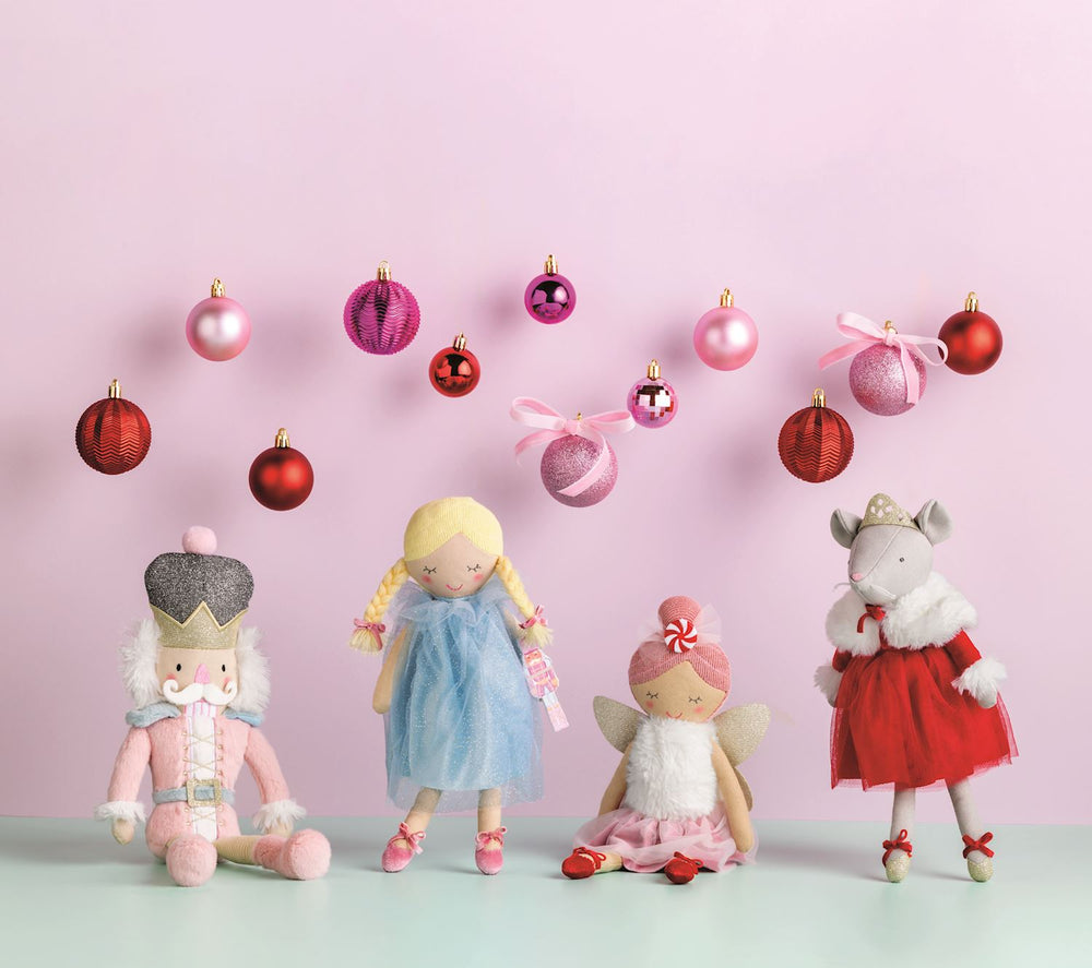 Faux linen Nutcracker plush doll in a pink uniform and hat.