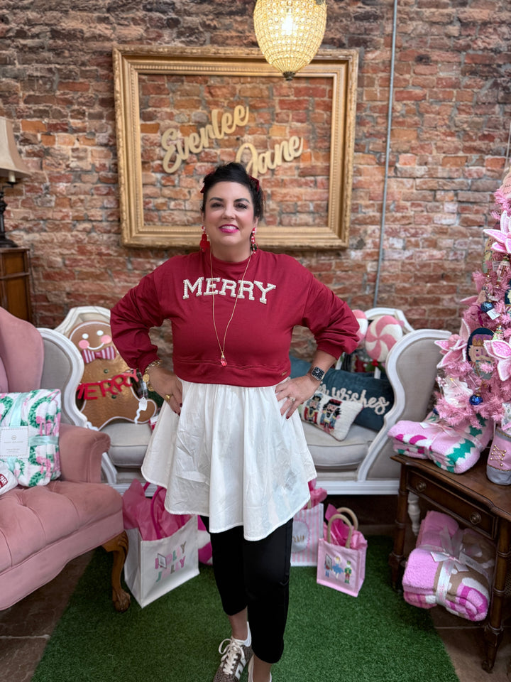 Twyla Red Merry Dress with long sleeves, sequin “MERRY” design, and white flared skirt overlay. Sizes XS-3XL.