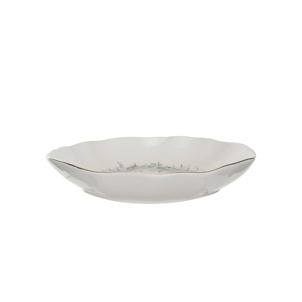 Round stoneware bowl with a green wreath design, gold-trimmed rim, and scalloped edge.