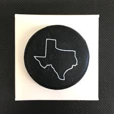 Black, circular wine bottle topper with white Texas outline; available in standard and large sizes for sealing bottles.