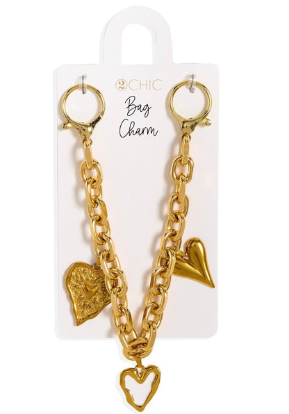 Charmed Life Chain Bag Charms: gold chain with two clasps and three gold heart-shaped charms. Available in one size.