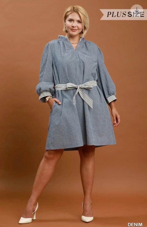 Blue knee-length, long-sleeve mini dress with white-gray striped sash. Available in plus sizes. Denim textured.