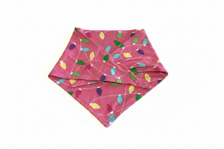 Pink Light It Up triangular dog bandana with colorful string-of-lights pattern.