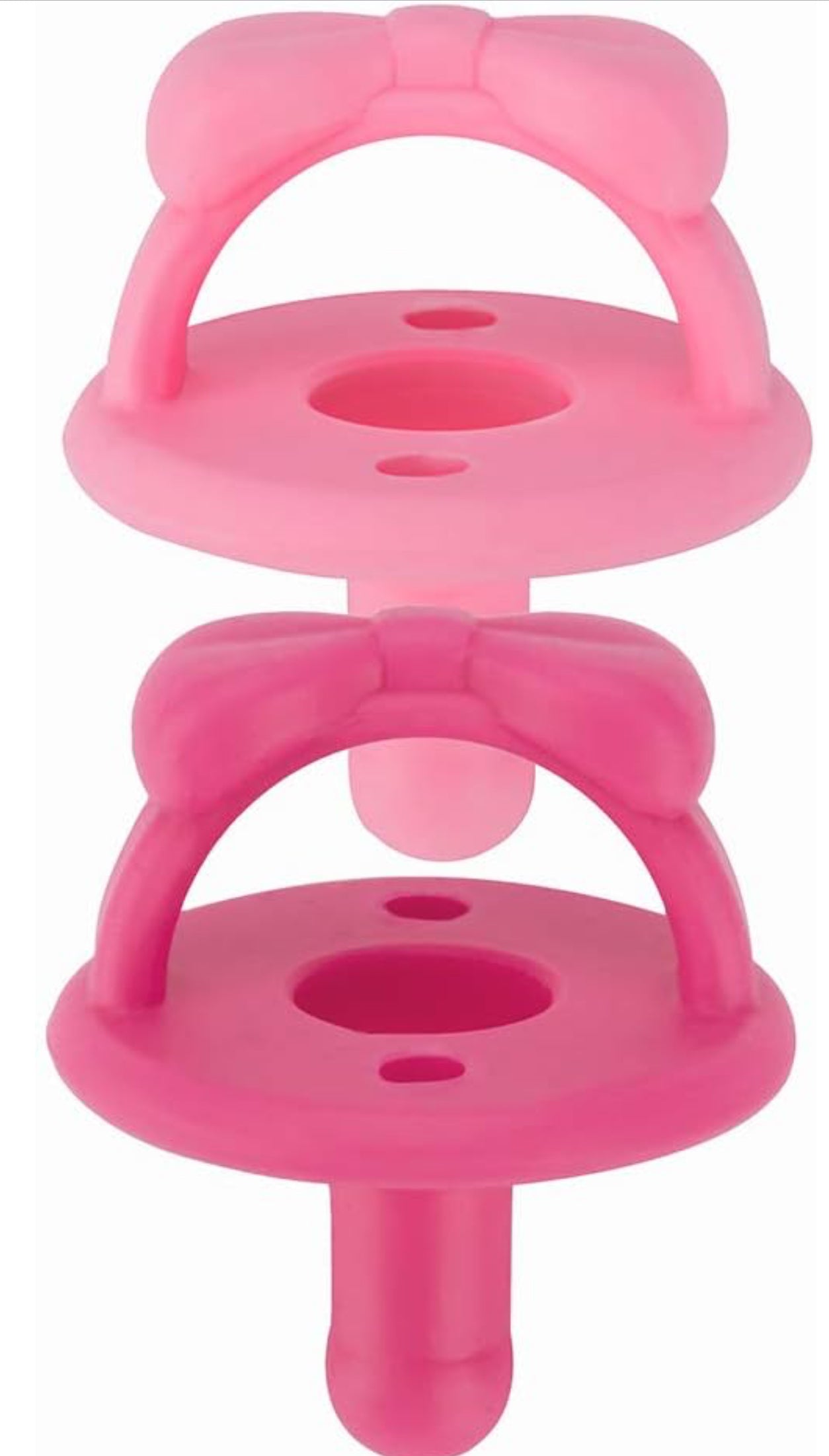 Two Sweetie Soother: Pink pacifiers stacked vertically, each with a looped handle at the top and a nipple at the bottom, set against a white background.