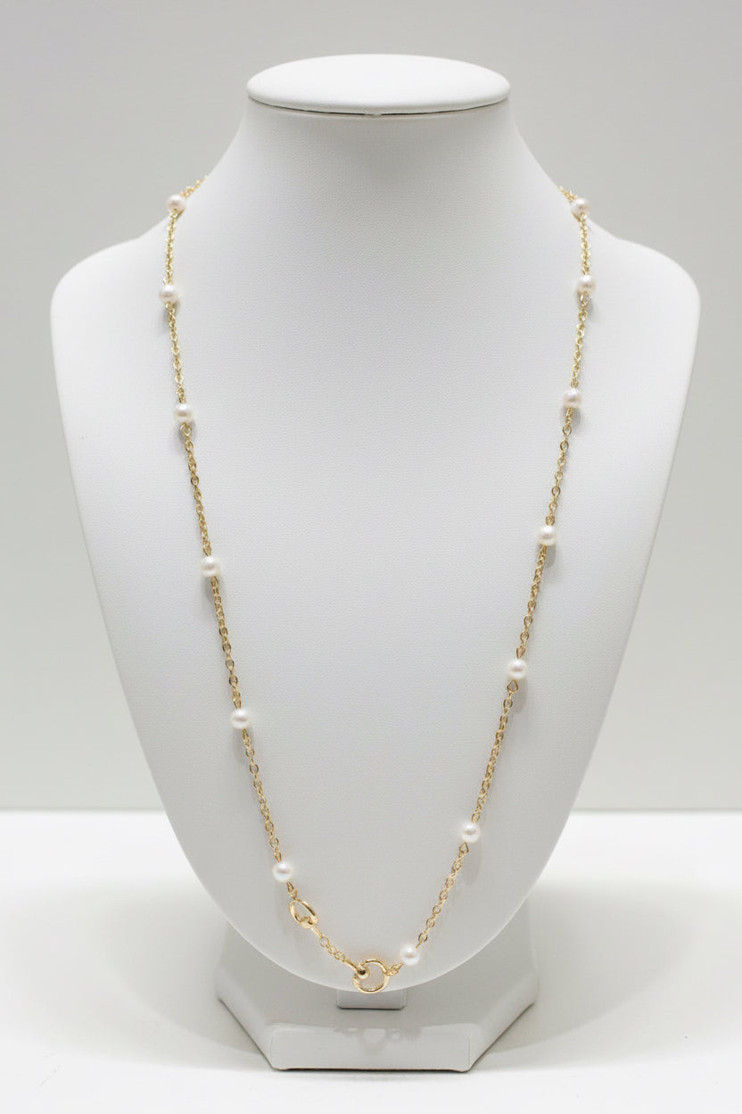 Dona Gold Pearl Necklace with a delicate gold-tone chain and evenly spaced small white beads. Available in 16-inch, 18-inch, and 20-inch lengths.