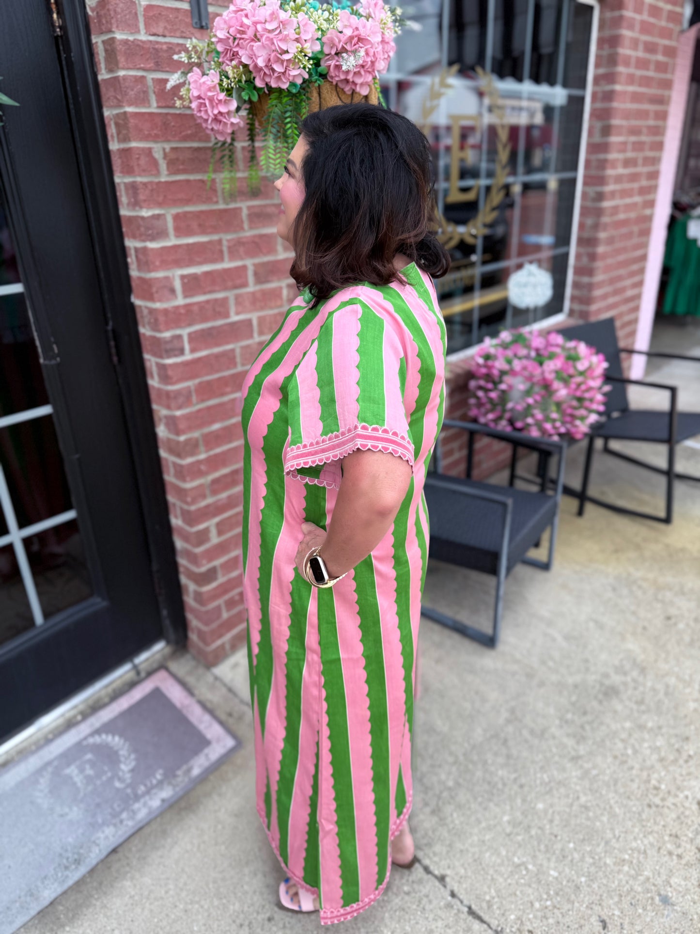 The Palace Palm Marisol Caftan is a maxi dress with bold pink and green stripes. Available in sizes XS–XL.