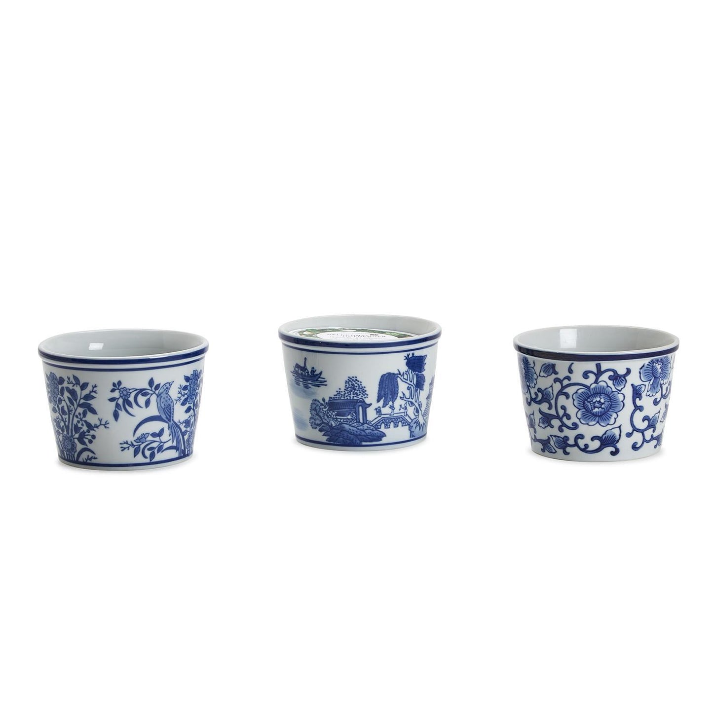 Three blue and white ceramic cups with floral and landscape designs on a white background