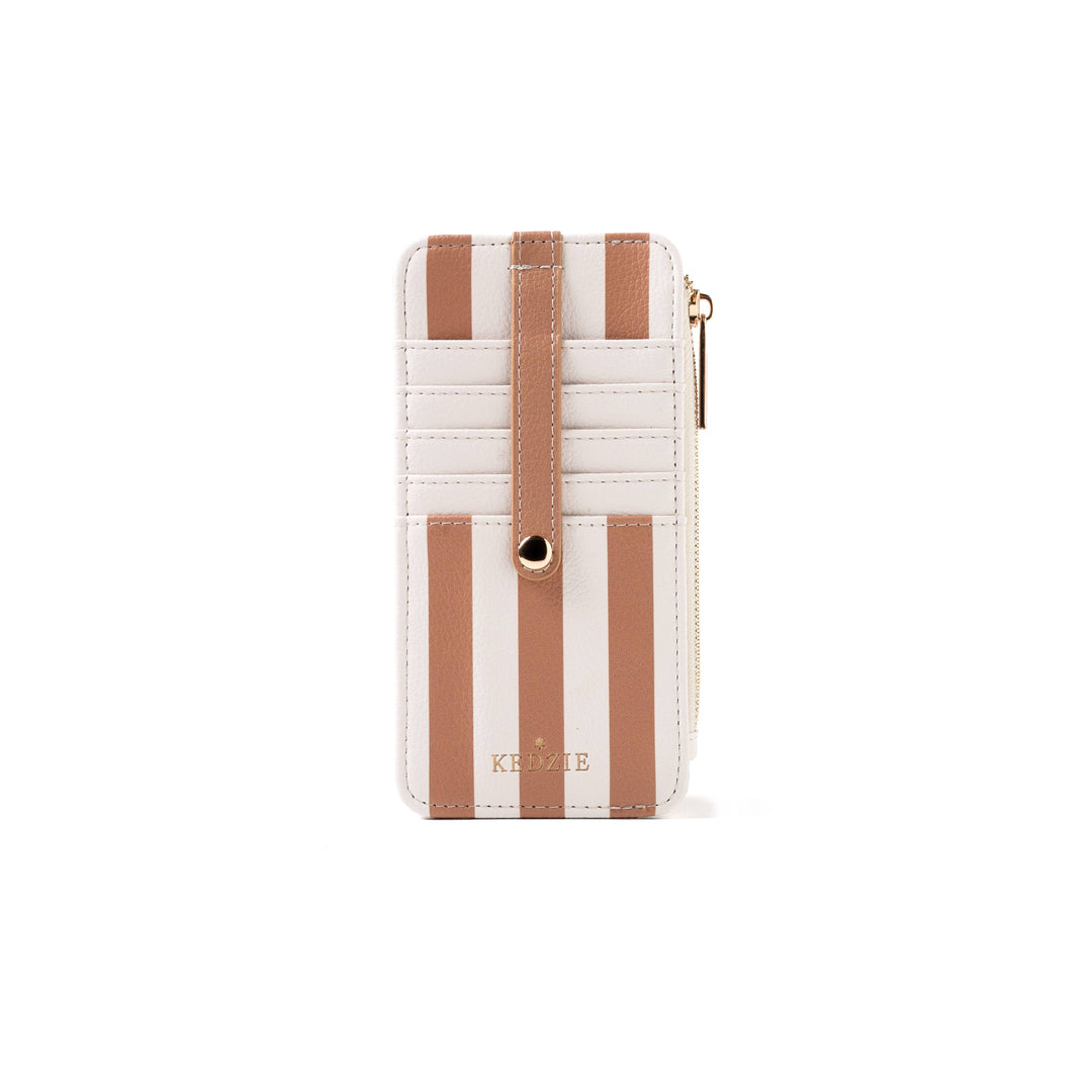 Beige and white vertically striped vegan leather cardholder with snap strap, zippered side, and gold “KEDZIE” logo at the bottom. Available in standard size.