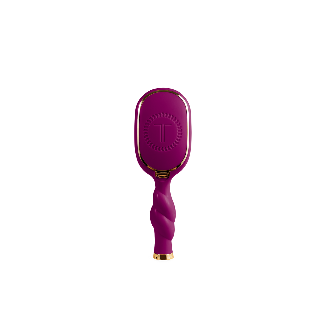 Mini Boar Bristle Hair Brush in Mulberry with twisted handle, gold accents, and “T” logo on back. Available in mini size.