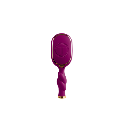 Mini Boar Bristle Hair Brush in Mulberry with twisted handle, gold accents, and “T” logo on back. Available in mini size.
