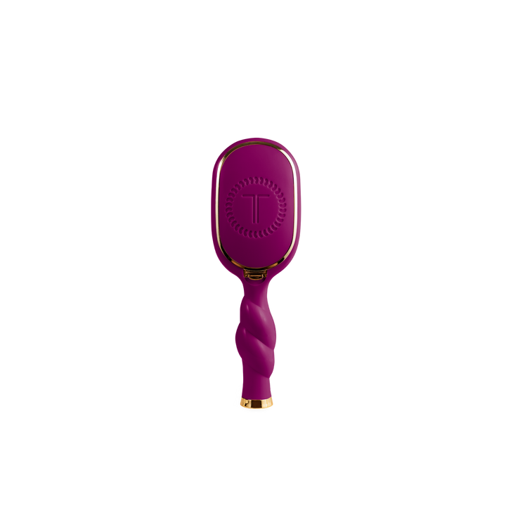 Mini Boar Bristle Hair Brush in Mulberry with twisted handle, gold accents, and “T” logo on back. Available in mini size.