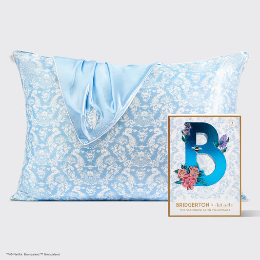 Kitsch x Bridgerton Satin Pillowcase in Toile De Blue with floral design, shown with matching blue satin sleep mask. Sizes: Standard, King.