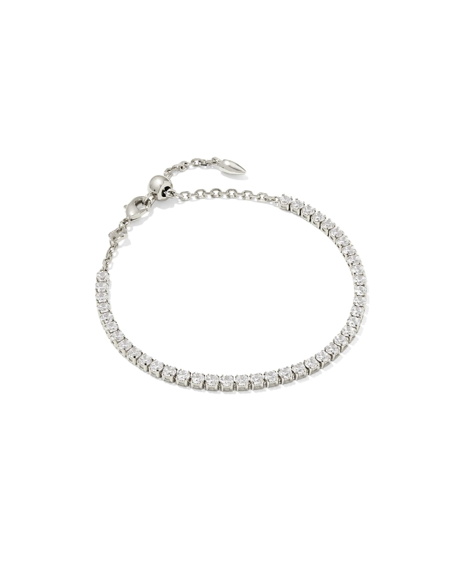 Delicate silver tennis bracelet with white CZ stones, adjustable chain, bead clasp. Available sizes: S, M, L.