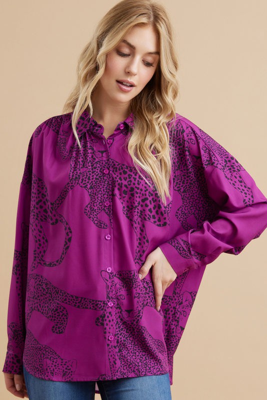 Magenta Satin Animal Print Top: loose, bright magenta button-up with bold leopard pattern. Available in sizes XS-XL.