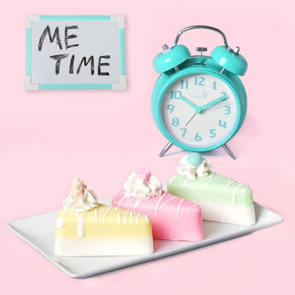 Three pastel-colored pie soaps from the Handmade Artisan Pie Soap Mix on a white plate. Available in small, medium, and large.