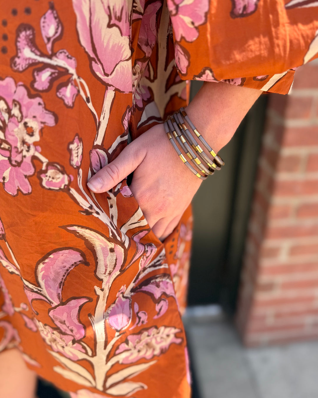 Autumn Rust Long-sleeve Dress with pink floral patterns and pockets. Available in sizes XS–XL.
