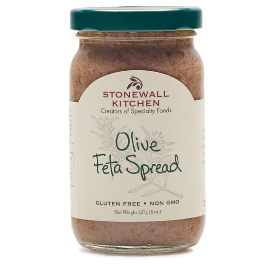 A jar of Olive Feta Spread from Stonewall Kitchen with a green lid. Gluten-free and non-GMO. Net weight: 227g (8oz).