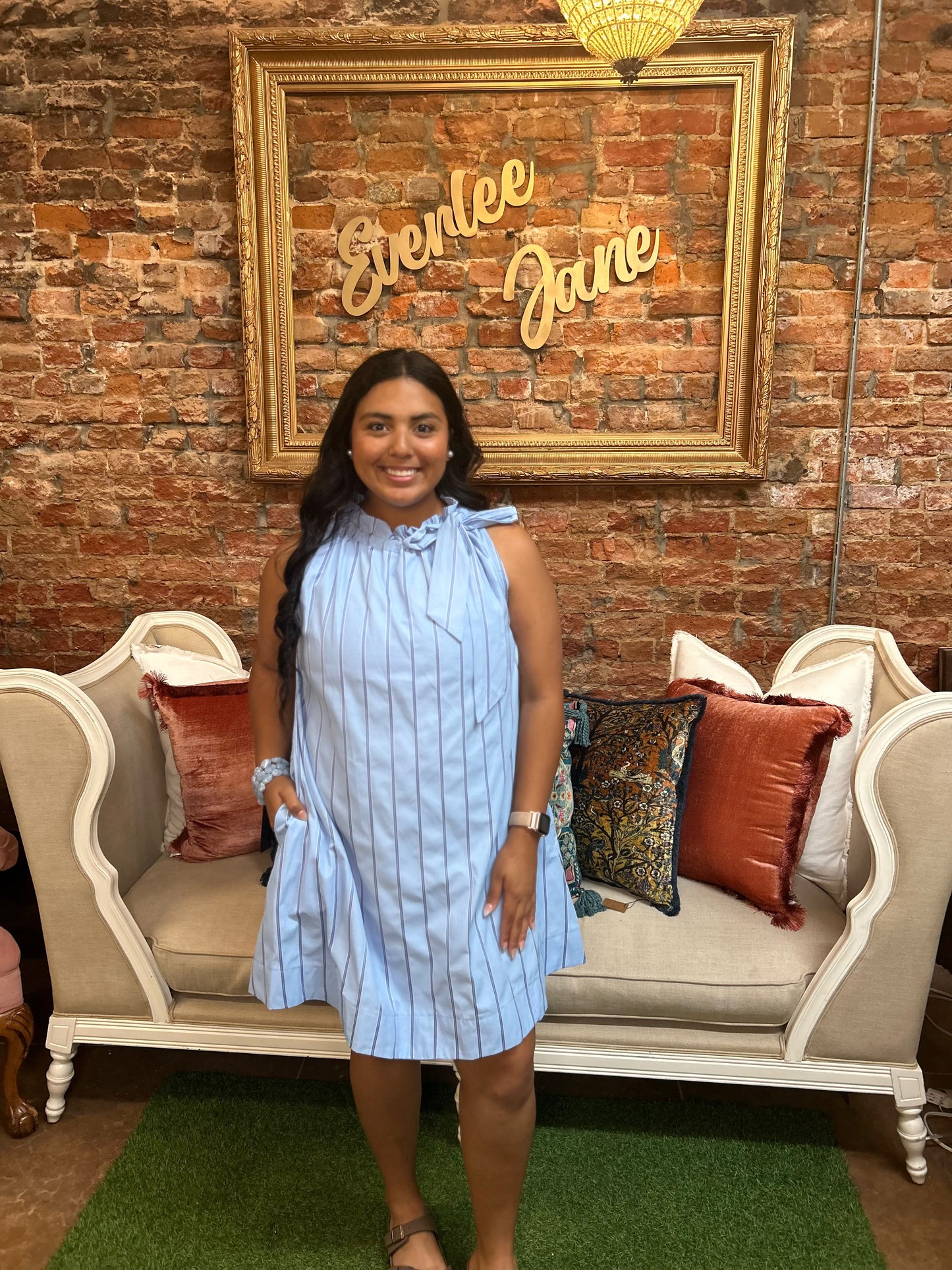 Pinstripe blue tie-neck sleeveless dress. Sizes available: XS–XL.