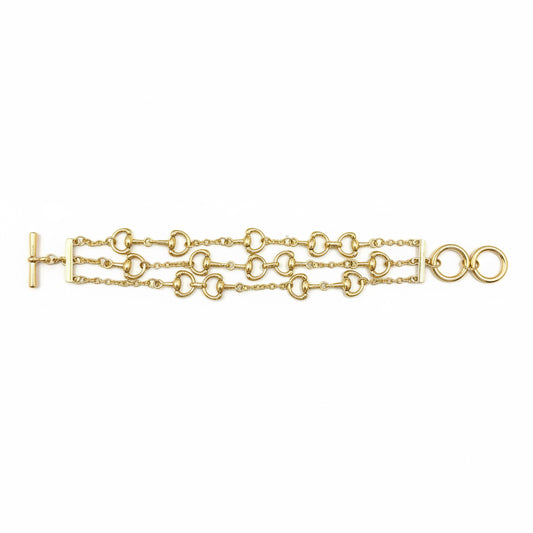 Mark Multi Strand Horse Bit Toggle Bracelet in gold with three layered strands and interlocking circular and oval links, featuring a left-side toggle clasp. Available sizes: S, M, L.