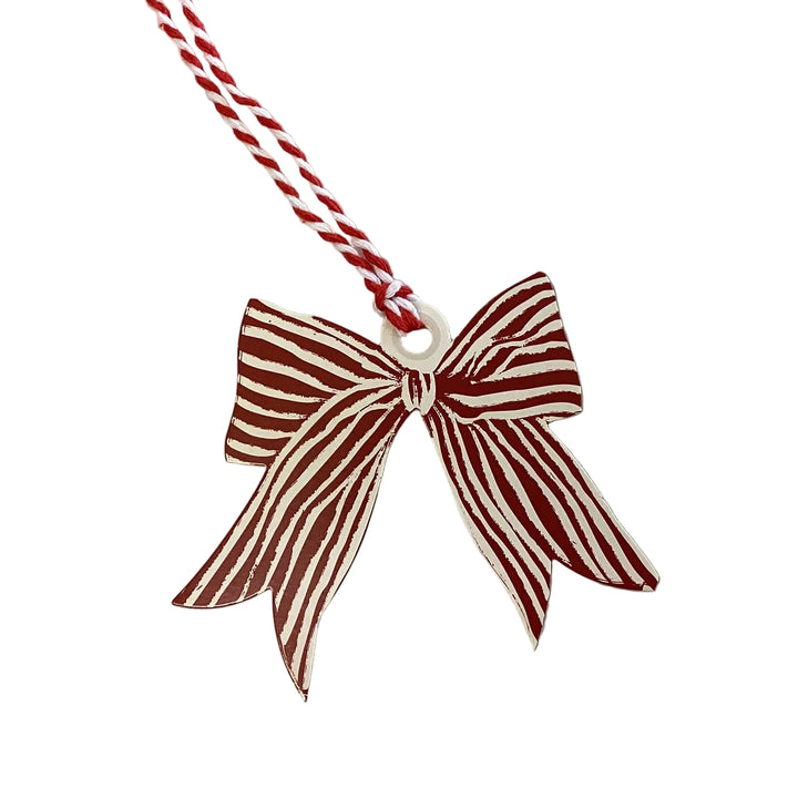 Bow-shaped gift tag book in dark red and white stripes on a twisted cord.