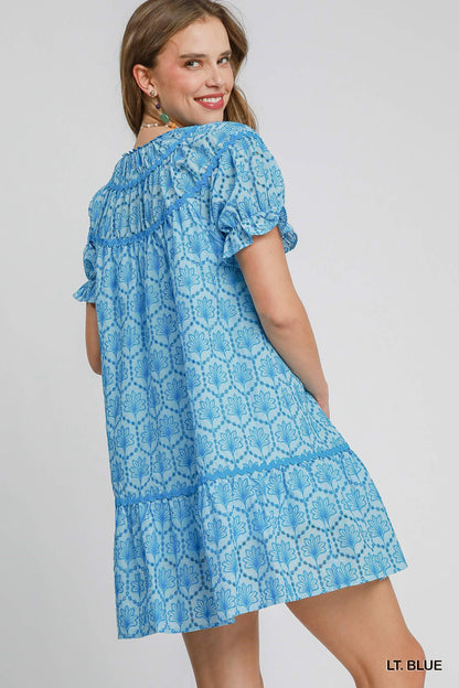 Celeste Eyelet Mini Dress: light blue, floral, short sleeves, ideal for spring/summer. Available in sizes XS-XL.