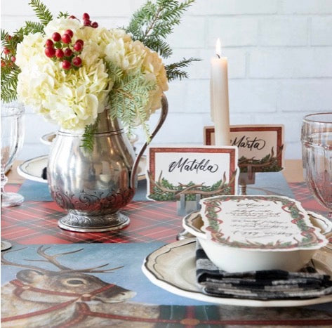 Red, black, and white plaid table runner with reindeer illustration. Available in multiple sizes.