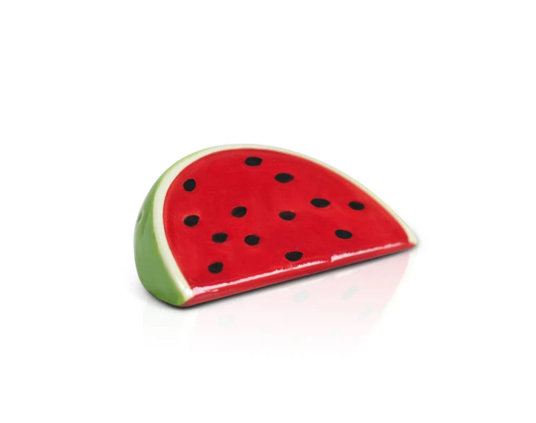 Nora Fleming Minis ceramic watermelon slice sculpture. Red interior with black seeds; glossy green rind. Can be placed upright. Sizes: One size available.