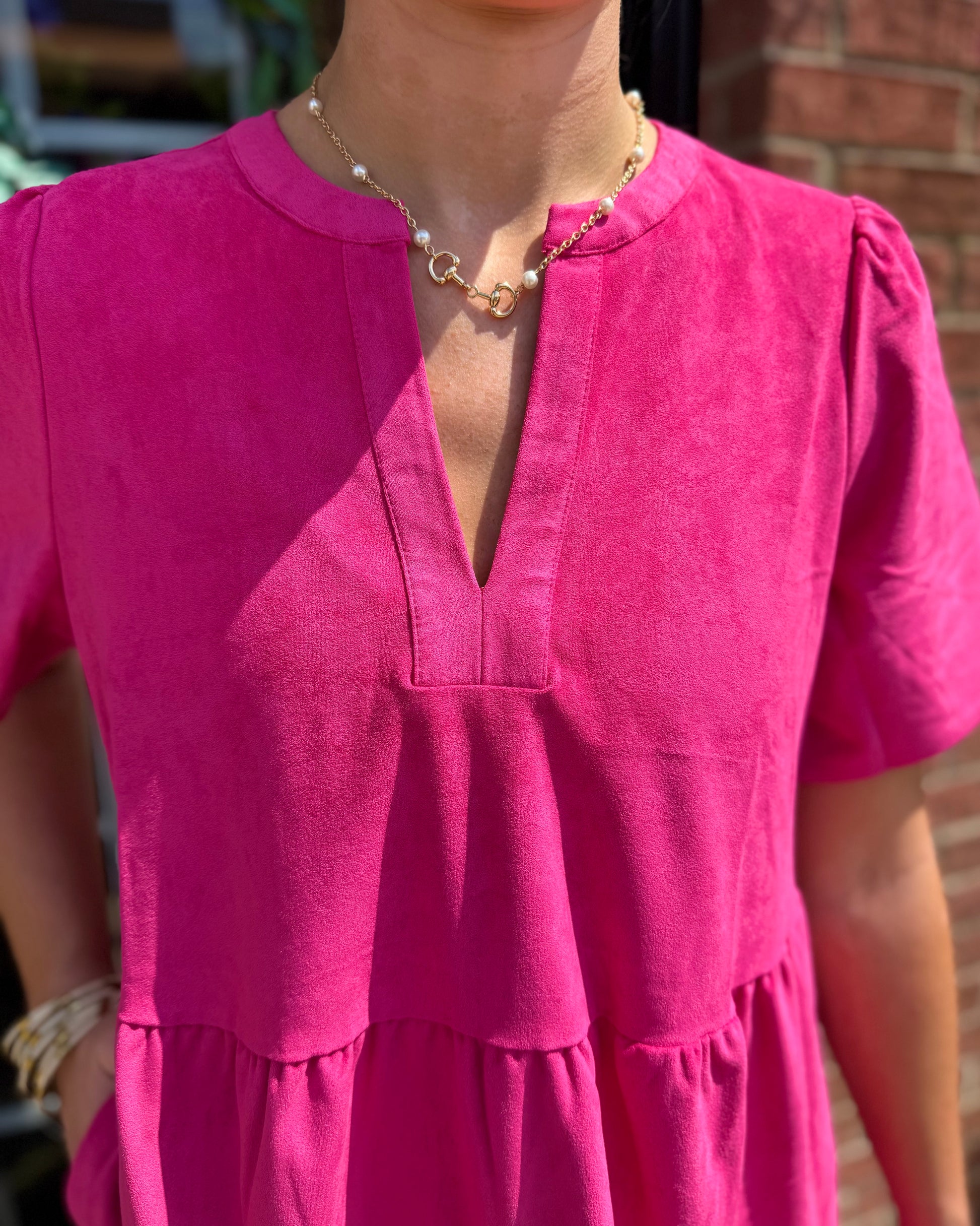Adelyn Pink Dress: bright pink, short-sleeve, v-neckline, available in sizes XS–XL.