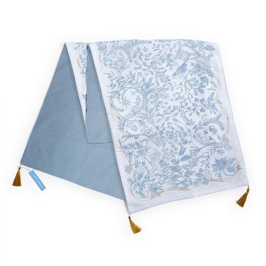 Gilded Cottage Double-Sided Table Runner with blue and white bird and botanical print, solid blue reverse, and gold corner tassels. Available in multiple sizes.
