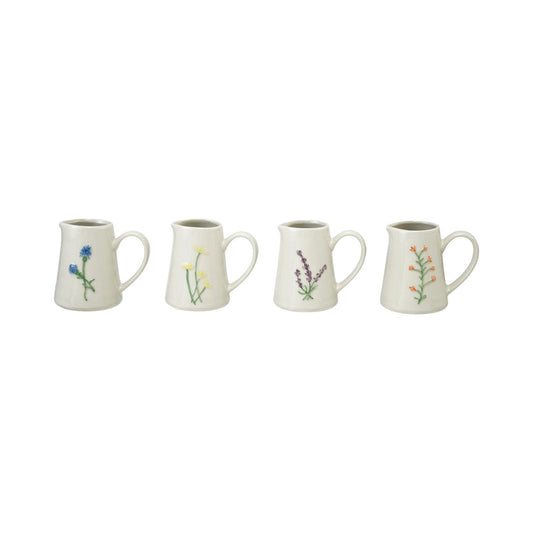 Set of four debossed stoneware creamers with blue, yellow, purple, and orange botanical designs. Sizes: small to large.
