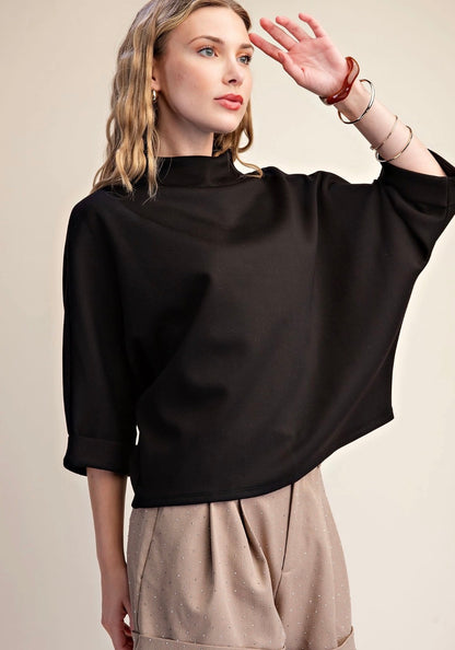 Everyday Mock Neck in black—loose-fit, 3/4 sleeves, mock-neck detail. Available in sizes XS–XL.