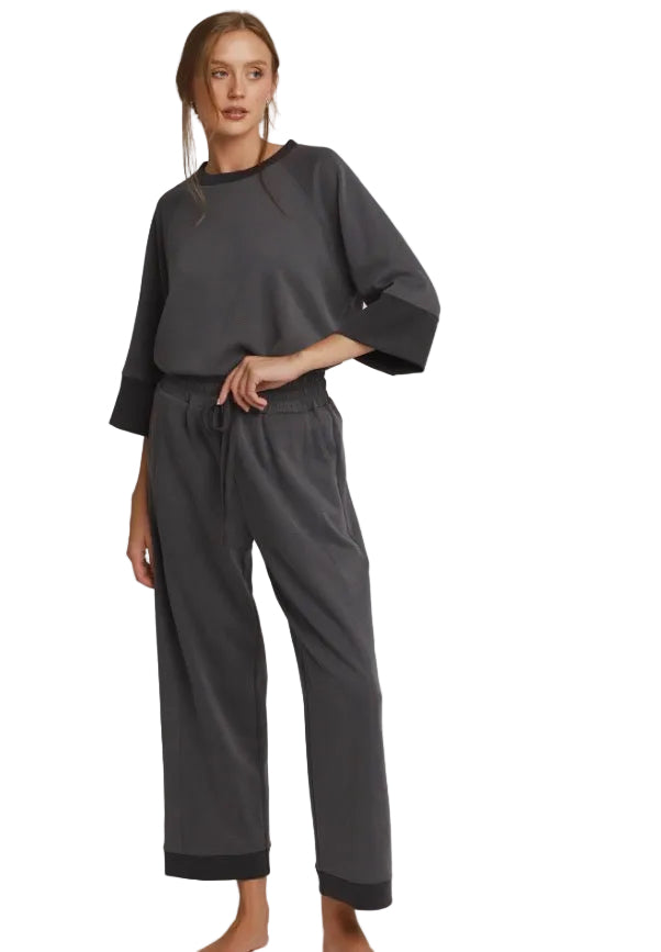 Charcoal Colorblock Straight Pants made from CloudKnit fabric with a loose fit, drawstring waist, and black cuffs at the hems. Available in sizes XS–XL.