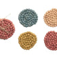 Handmade wool felt ball coasters in pink, blue, beige, yellow, and red. Available in round; sizes: 4", 5", and 6".