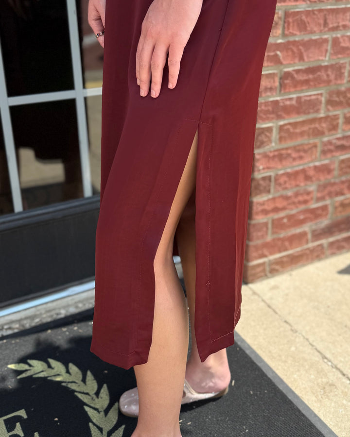 Satin Tie Back Midi Dress in burgundy with a high slit. Available in sizes XS-XL.