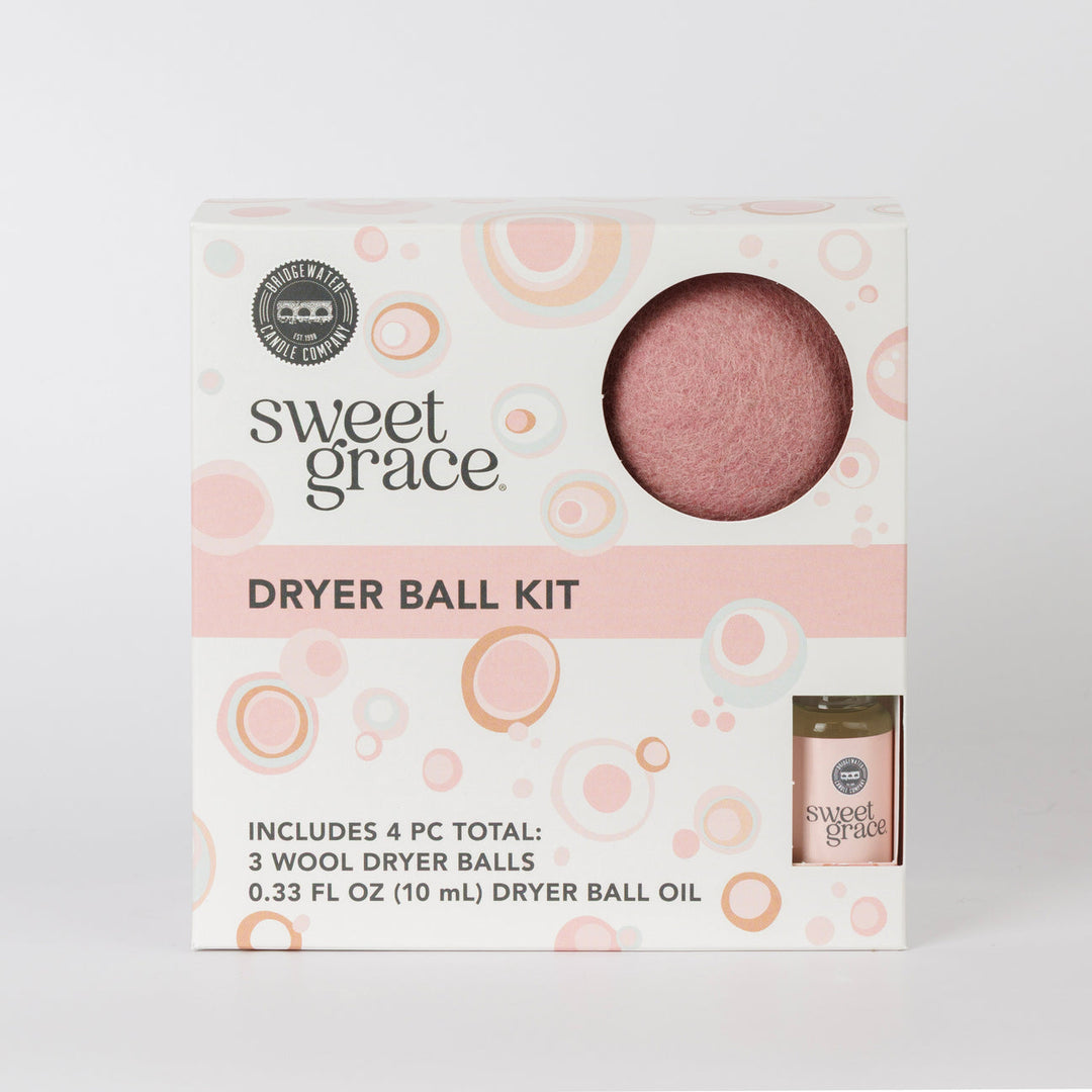Dryer Ball Kits Sweet Grace: 3 wool dryer balls, fragranced laundry oil, white box with pink/orange accents. Sizes not shown.