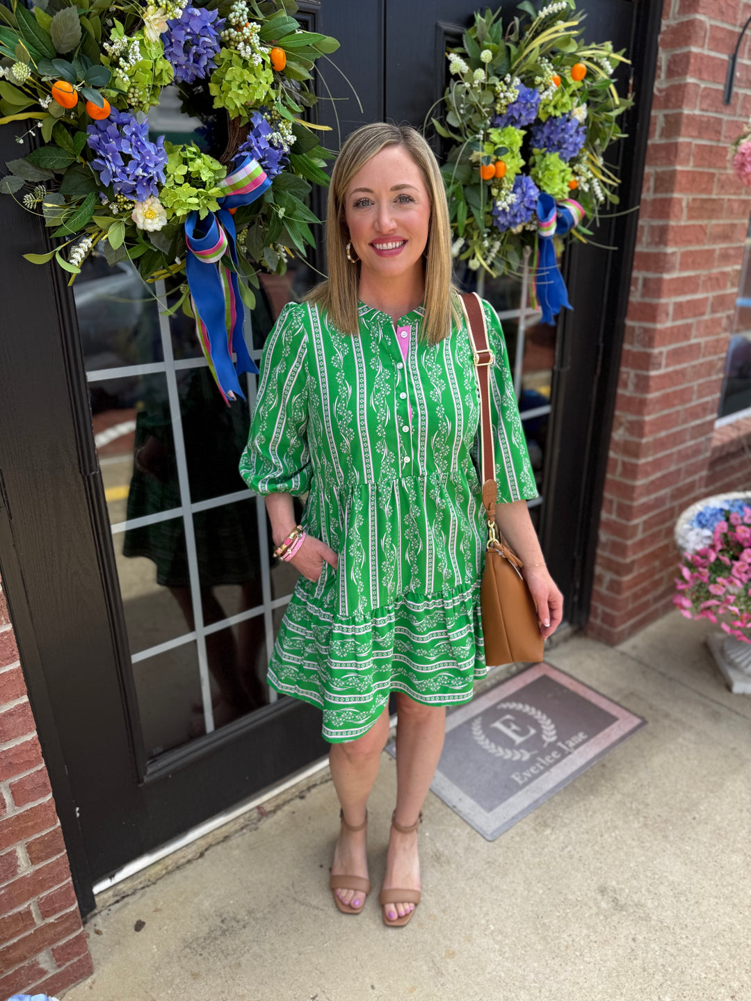 Riley Garden Lace Green Dress with 3/4 sleeves and tiered skirt. Available in sizes XS–XL.