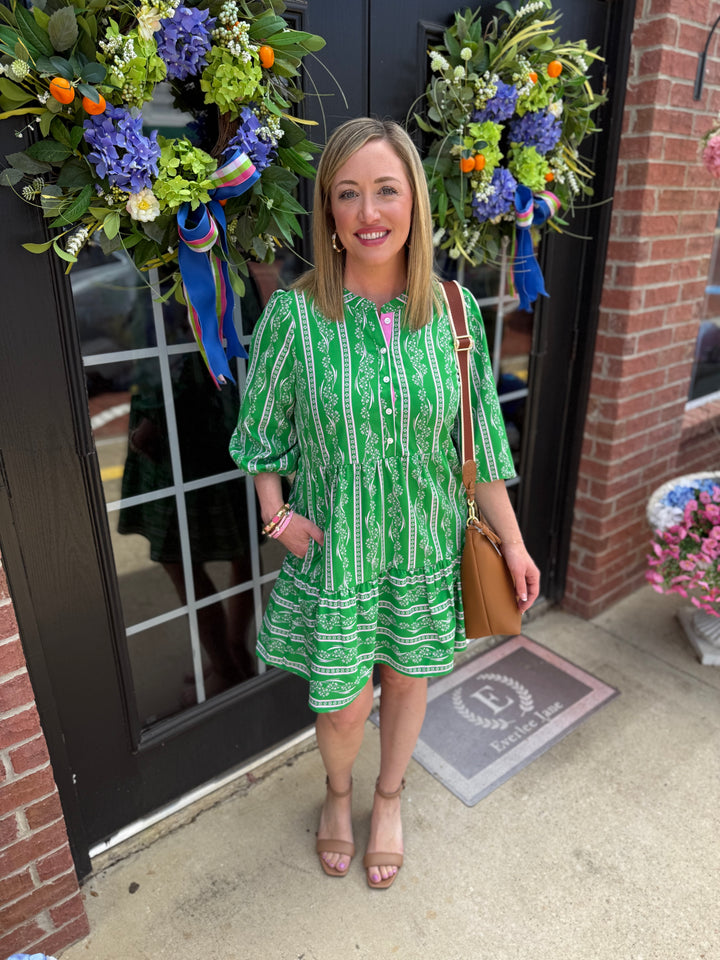 Riley Garden Lace Green Dress with 3/4 sleeves and tiered skirt. Available in sizes XS–XL.