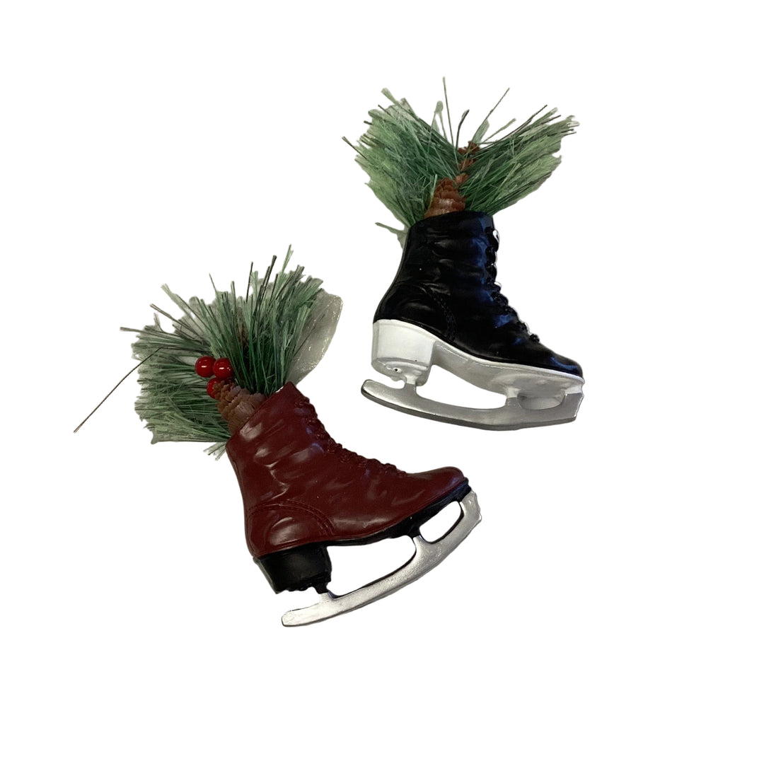 Black and maroon ice skate boot ornaments filled with pine needles and red berries.