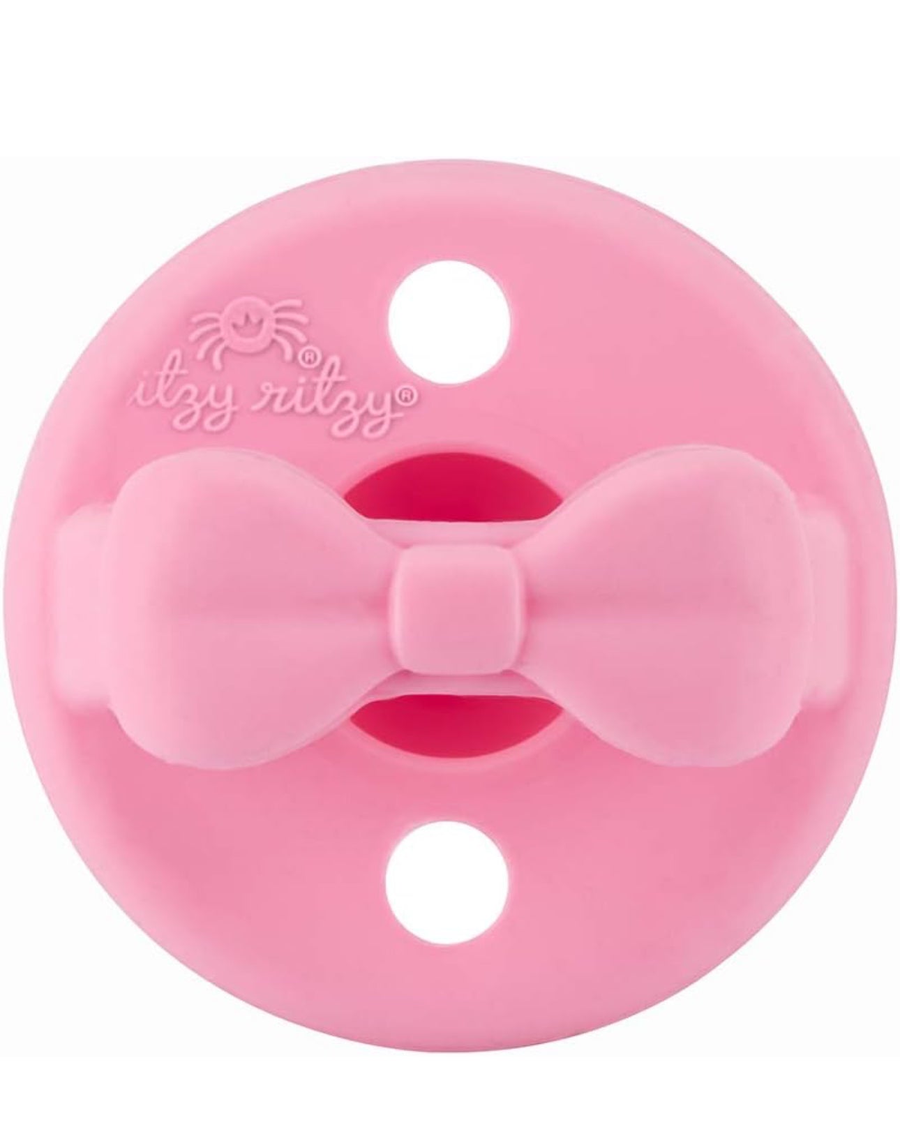 A Sweetie Soother: Pink food-grade silicone baby pacifier featuring a bow design in the center, with the "itzy ritzy" logo embossed above the bow.