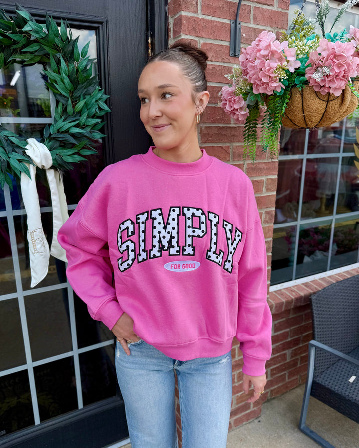 Pink “Simply Polka Dot Crew Neck” sweatshirt with varsity lettering; available in sizes S-XL.