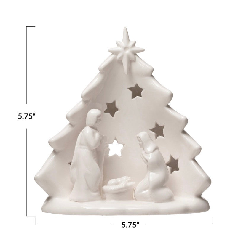 White ceramic nativity tree candle holder with scene cutout and star openings, 5.75 inches tall and wide.