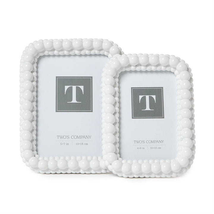 White Double Hobnail Frame set includes one large and one small white picture frame, each with a rounded hobnail beaded border. Sizes available: large and small.