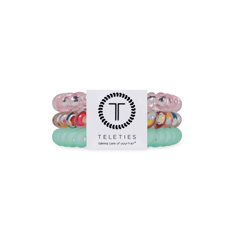 Three Classic Blue Lagoon TELETIES coiled hair ties in pastel blue and clear; available in small and large sizes.