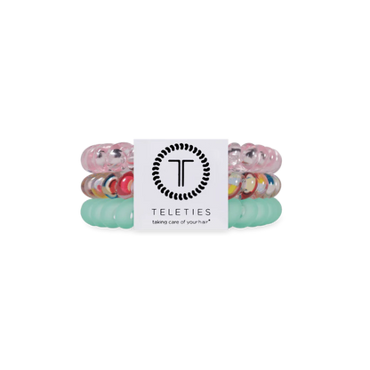 Three Classic Blue Lagoon TELETIES coiled hair ties in pastel blue and clear; available in small and large sizes.