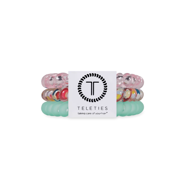 Three Classic Blue Lagoon TELETIES coiled hair ties in pastel blue and clear; available in small and large sizes.