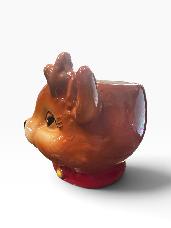 Reindeer bowl shaped like a reindeer head with brown fur, antlers, and a red collar with a yellow bell.