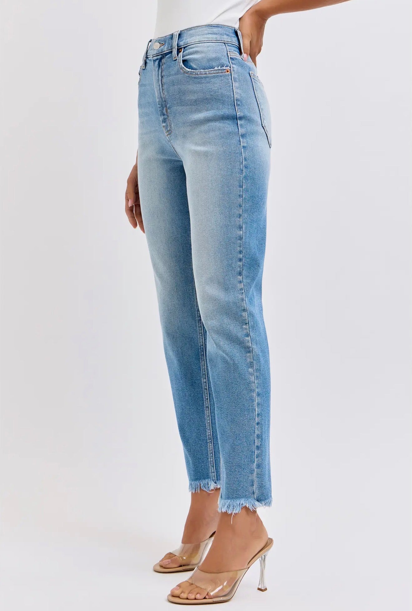 Distressed High Rise Mom Jeans with raw, frayed hem. Available in sizes 24–32.